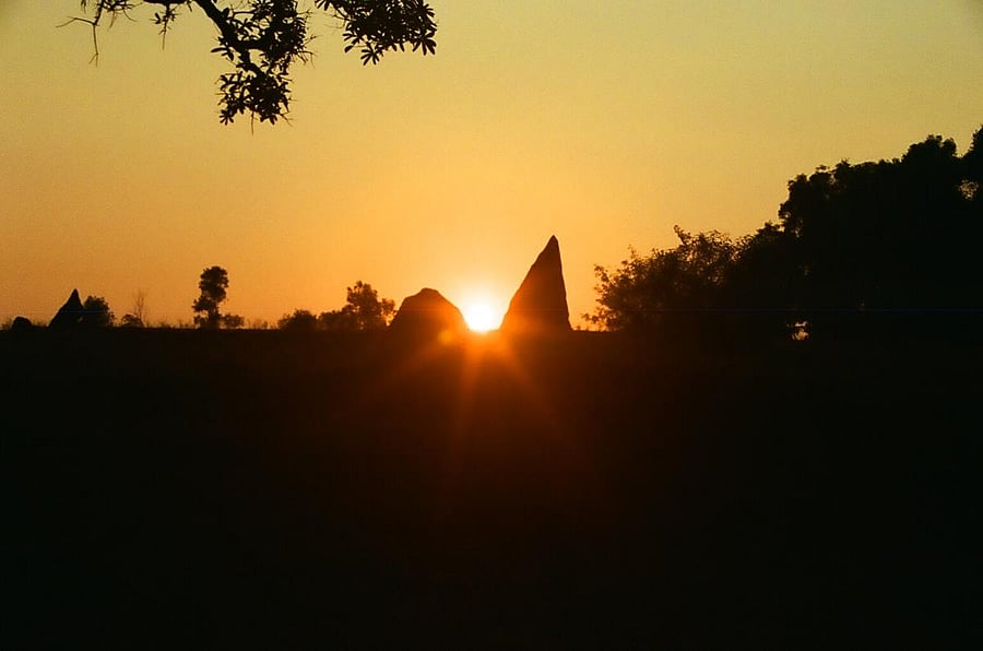 Two menhirs at Nilaskal framing the setting sun on winter solstice