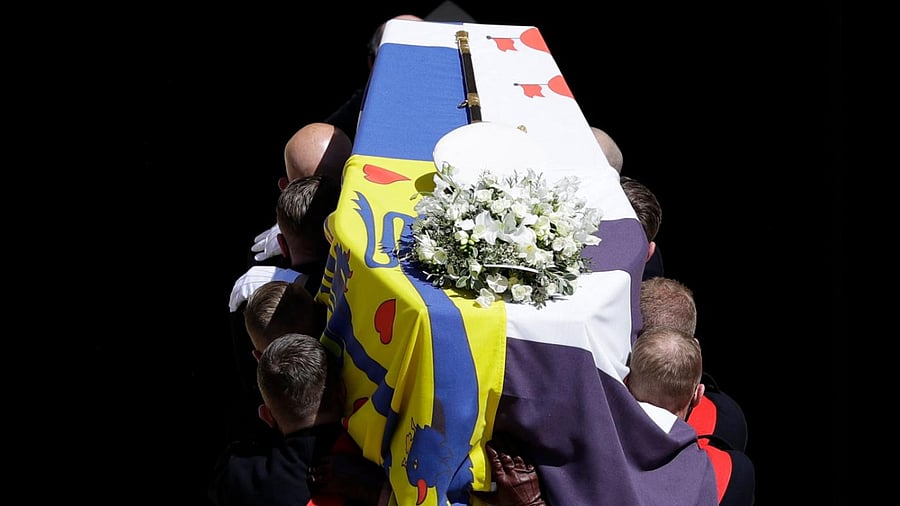 Pallbearers of the Royal Marines carry the coffin on the West Steps of St George's Chapel during the ceremonial funeral procession of Britain's Prince Philip, Duke of Edinburgh in Windsor Castle in Windsor, west of London, on April 17, 2021. Credit: AFP Photo