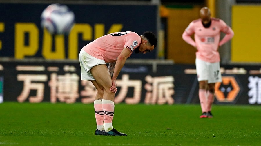 Sheffield United's English midfielder Kean Bryan reacts as defeat means they are relegated from the Premier League, after the English Premier League football match between Wolverhampton Wanderers and Sheffield United at the Molineux stadium in Wolverhampton. Credit: AFP photo
