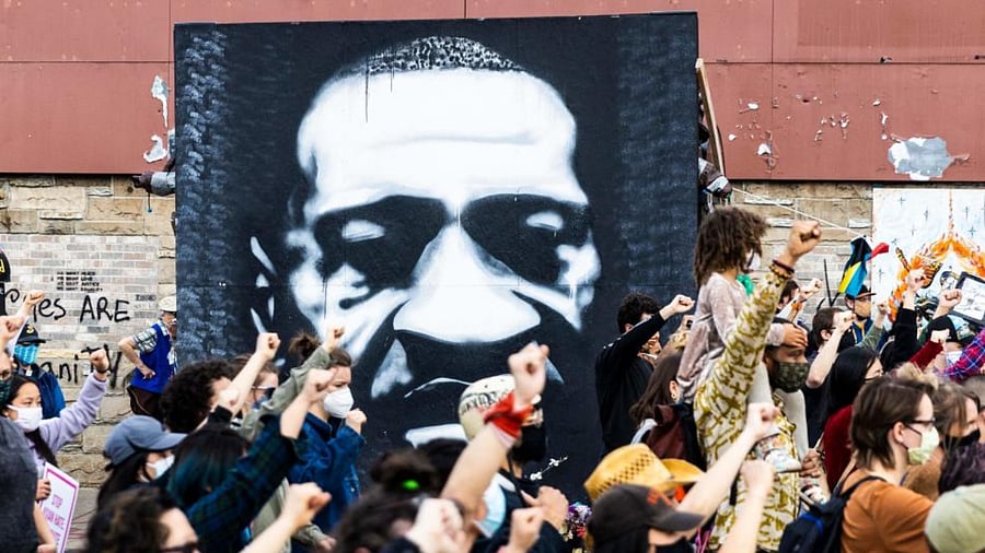People raise their fist during a demonstration near the George Floyd Memorial in Minneapolis, Minnesota on April 18, 2021. Credit: AFP Photo