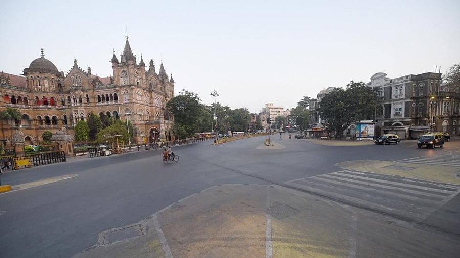 City streets near Chatrapati Shivaji Maharaj Terminus wear a deserted look during weekend lockdown, imposed to curb the surge in coronavirus cases in Mumbai, Sunday. Credit: PTI photo. 