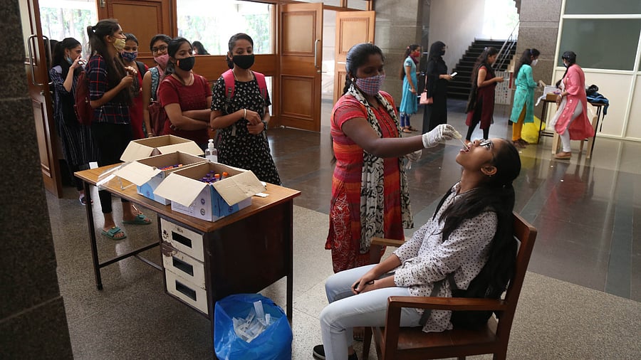 Students of NMKRV College undergoing swab tests for Covid-19. Credit: DH Photo