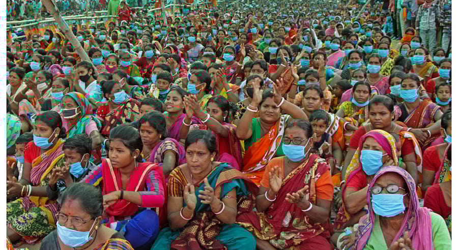 BJP supporters of Suvendu Adhikary being garlanded by party leaders during an election campaign rally for the West Bengal Assembly Polls, at Illambazar in Birbhum district, Saturday, April 17, 2021.  Credit: PTI Photo
