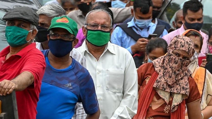 People wait in a queue to receive the Covid-19 coronavirus vaccine at a vaccination centre in Mumbai on April 22, 2021. Credit: AFP Photo