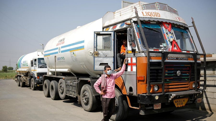A driver stands next to an empty tanker as he waits for his turn to fill liquid oxygen. Credit: Reuters Photo