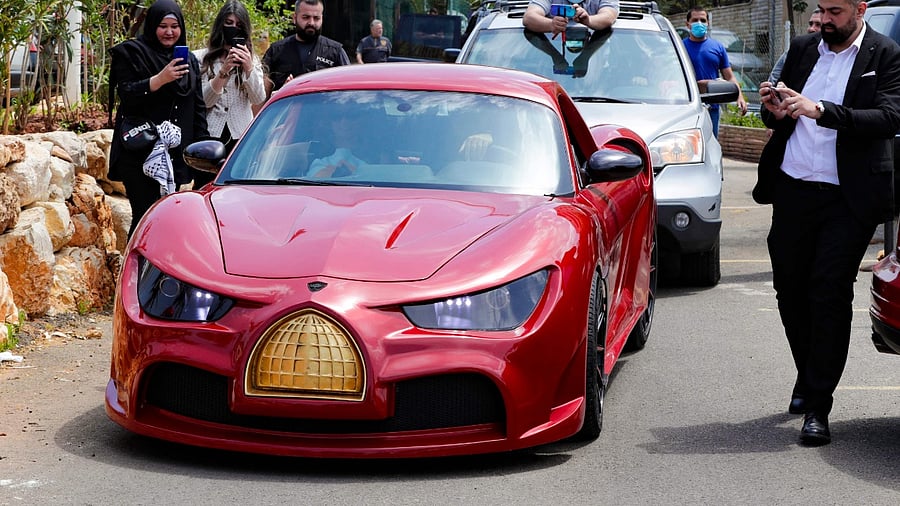 The red sports car with butterfly doors is named "Quds Rise". Credit: AFP Photo
