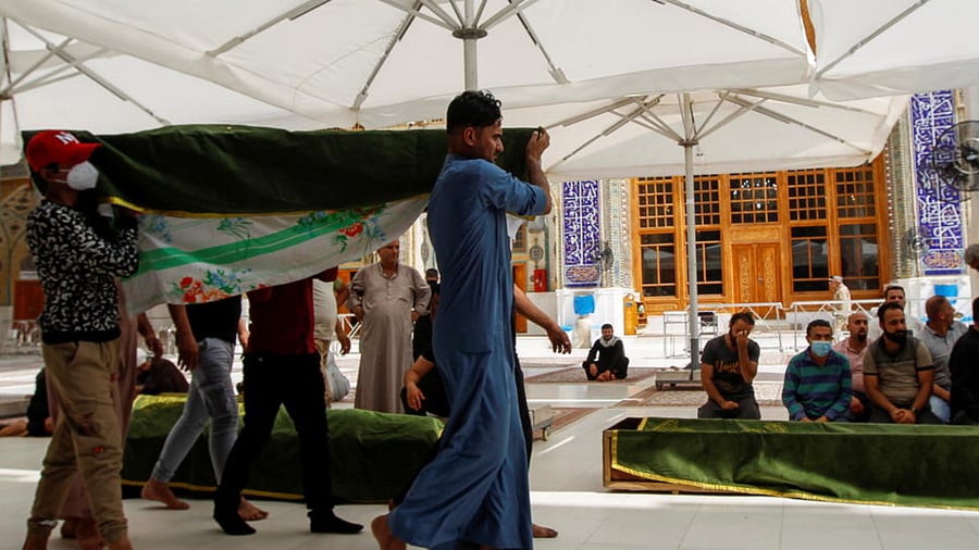 Mourners attend the funeral of people who were killed in a fire at a hospital in southeastern Baghdad that had been equipped to house Covid-19 patients, in Najaf, Iraq, April 25, 2021. Credit: Reuters Photo