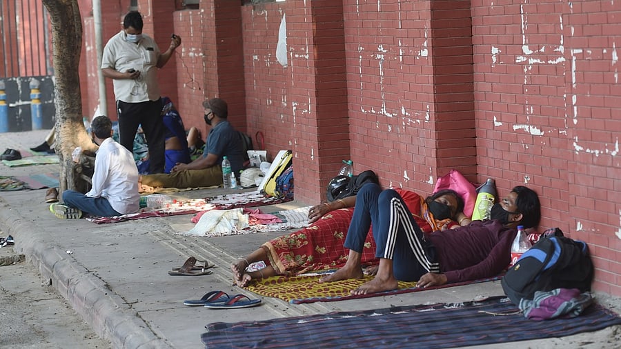 Family members of Covid-19 patients rest outside LNJP Hospital, in New Delhi, Saturday, April 24, 2021. Credit: PTI Photo