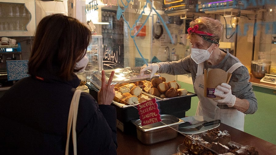 A customer orders "Buchteln", an Austrian speciality filled with marmalade, as a grandmother packs them, in the Vollpension cafe, in Vienna. Credit: AFP photo