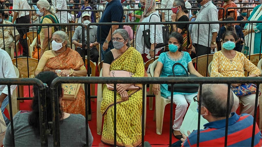 People queue up to receive a dose of a Covid-19 vaccine at a vaccination centre in Mumbai. Credit: AFP photo.
