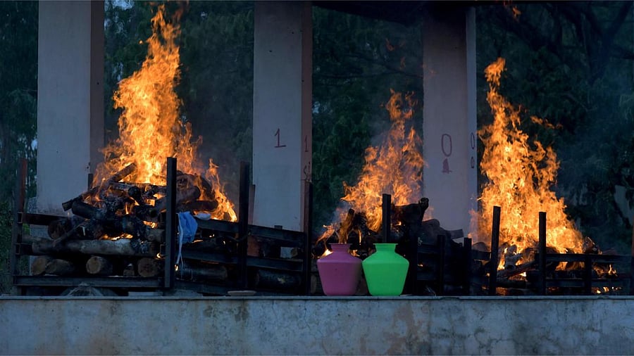 Burning pyres of victims who lost their lives due to the Covid-19 are seen at an open crematorium in Bangalore. Credit: AFP photo.