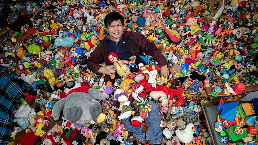 Percival Lugue, who has the Guinness world record for the largest fast-food toy collection, poses with his toy collection in his home in Apalit, Pampanga province, Philippines, April 20, 2021. Credit: Reuters Photo