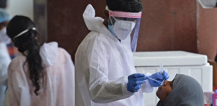 Passengers arriving on international flights get Covid-19 screening done at Anna International airport in Chennai. Credit: AFP Photo