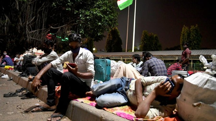 People wait at the city railway station for trains to return to their hometowns ahead of the close-down in the state on Tuesday. Credit: DH Photo/Pushkar V