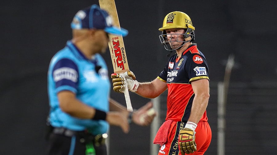 AB de Villiers raises his bat after scoring a fifty against Delhi Capitals at the Narendra Modi Stadium, Ahmedabad. Credit: PTI Photo