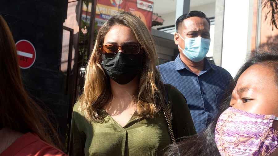 Russian influencer Leia Se, center, walks from the immigration office at Jimbaran, Bali. Credit: AP/PTI photo