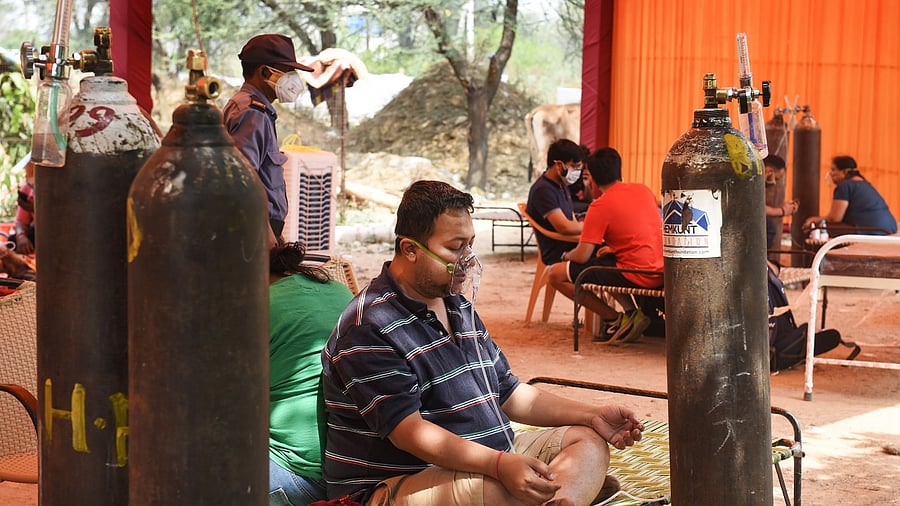 A Covid-19 patient on oxygen support, provided by an NGO, is seen during the ongoing second wave of coronavirus pandemic, in Gurugram. Credit PTI Photo