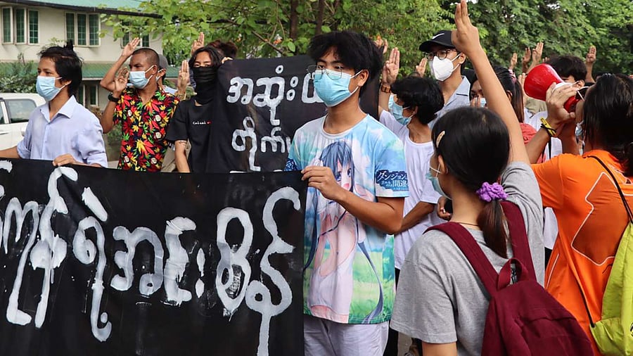 Protesters marching with banners as they take part in a demonstration against the military coup in Insein township in Yangon. Credit: AFP Photo