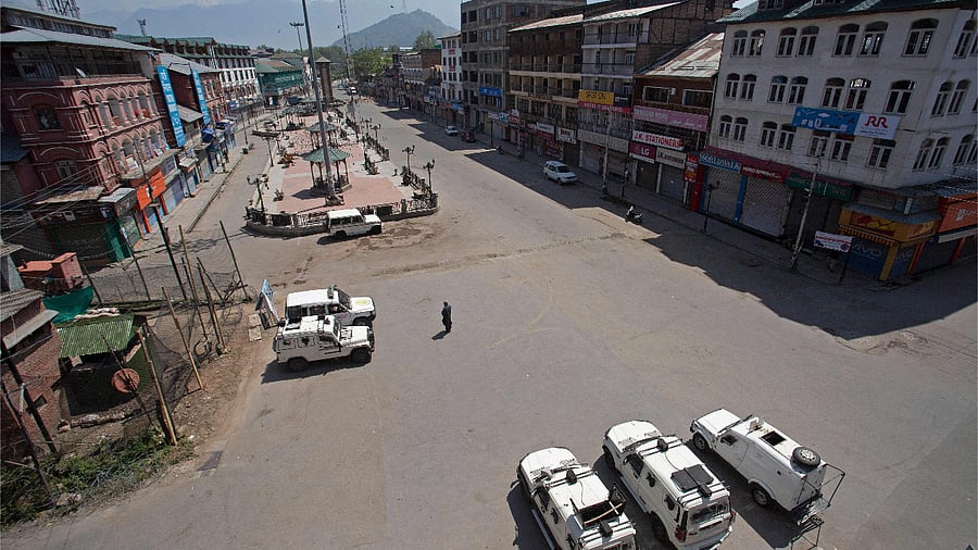 A man walks through a deserted street in a closed market area during a lockdown amid the Covid-19 pandemic. Credit: AFP Photo