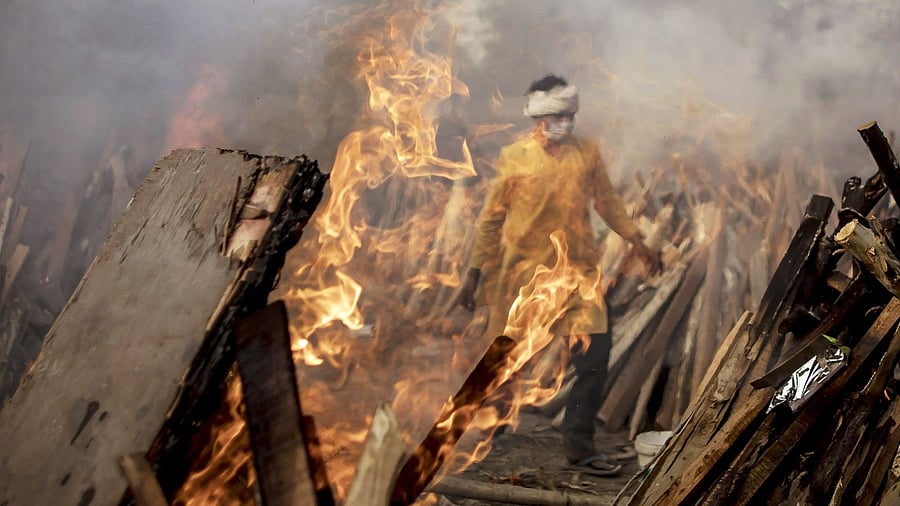 Photos of the Tianhe module launch and its fuel burn-off were compared with what appeared to be a mass outdoor cremation in India. Credit: Bloomberg