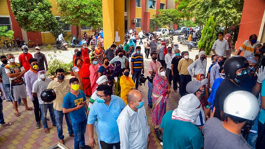  Beneficiaries above 18 years of age wait to receive the first shot of COVID-19 vaccine, in Varanasi. Credit: PTI Photo