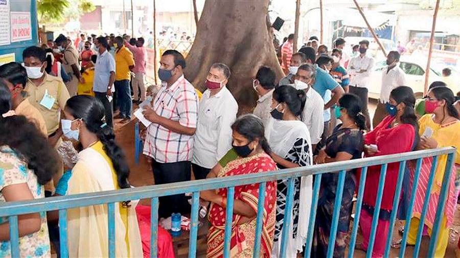 People waiting to cast their votes for the Puducherry Assembly Election 2021. Credit: PTI Photo