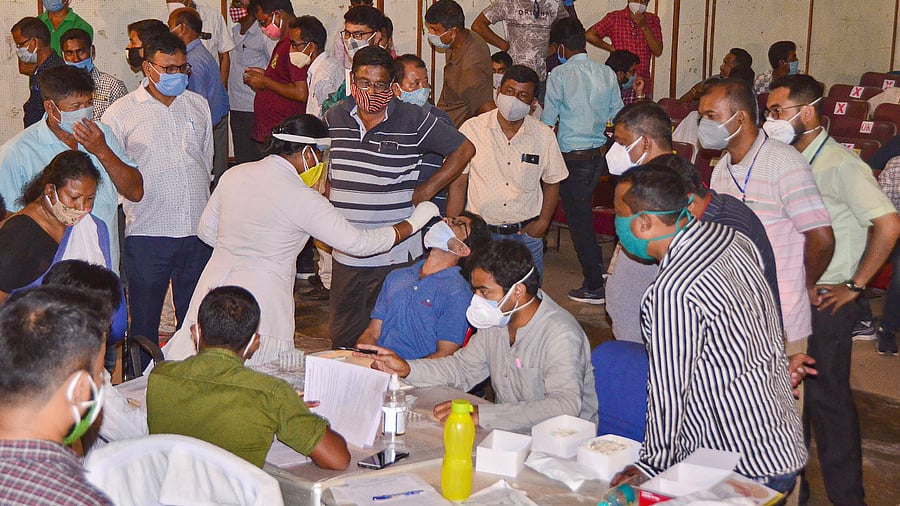 Officials wait to undergo Covid-19 testing on the eve of counting day of Assam Assembly Polls, in Tezpur. Credit: PTI Photo