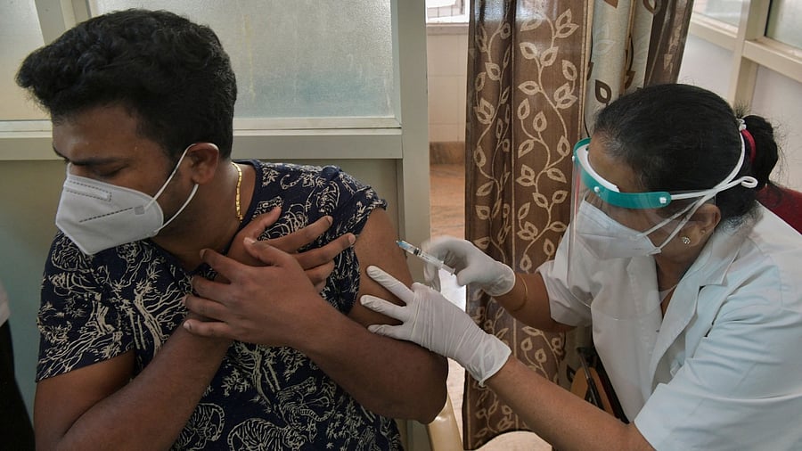 A medical worker inoculates a man with a dose of the Covaxin Covid-19 coronavirus vaccine at a vaccination centre in KC General government hospital. Credit: AFP Photo
