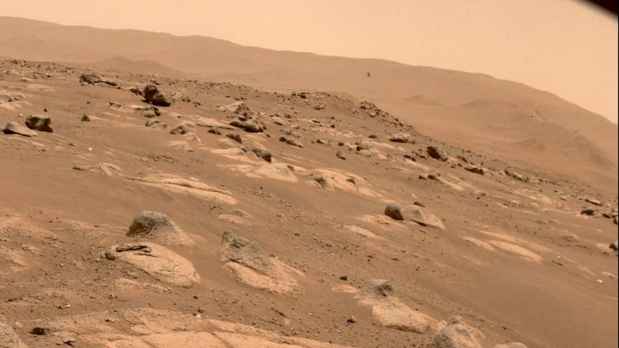 This NASA photo obtained May 2, 2021 shows NASA's Ingenuity Mars Helicopter viewed by one of the hazard cameras aboard the Perseverance rover during the helicopter's fourth flight. Credit: AFP File Photo