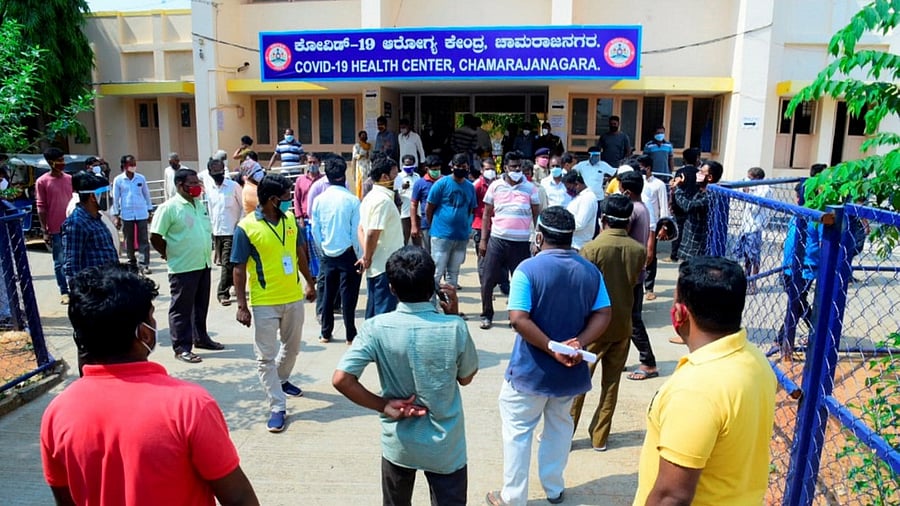 Relatives wait outside after 24 Covid- 19 patients died due to shortage of oxygen cylinders in Chamarajanagar. Credit: PTI Photo