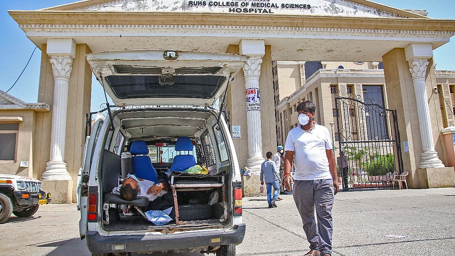 A Covid-19 patient waits in an ambulance outside at RUHS College of Medical Sciences Hospital, amid shortage of oxygen and beds due to surge in coronavirus cases, in Jaipur. Credit: PTI Photo