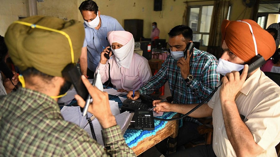 Public servants work at a Covid-19 coronavirus helpdesk at the Red Cross Bhawan in Amritsar on April 27, 2021. Credit: AFP Photo