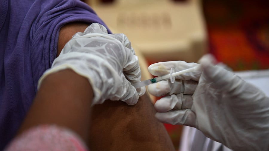 A medical worker inoculates a man with a dose of the Covaxin vaccine against the Covid-19 coronavirus at a vaccination centre in Mumbai. Credit: AFP Photo