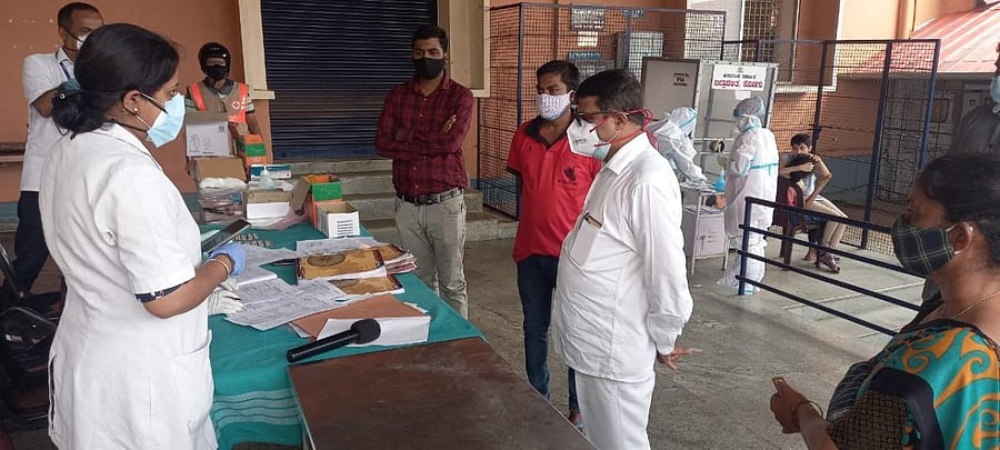 MLA M P Appachu Ranjan visits the vaccination centre at Raitha Bhavana in Kushalnagar.
