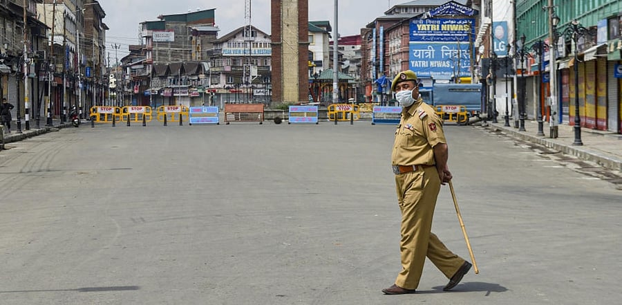 A policeman keeps vigil near Lal Chowk during the COVID-induced strict lockdown, as coronavirus cases surge in Srinagar, Wednesday, May 12, 2021. Credit: PTI Photo