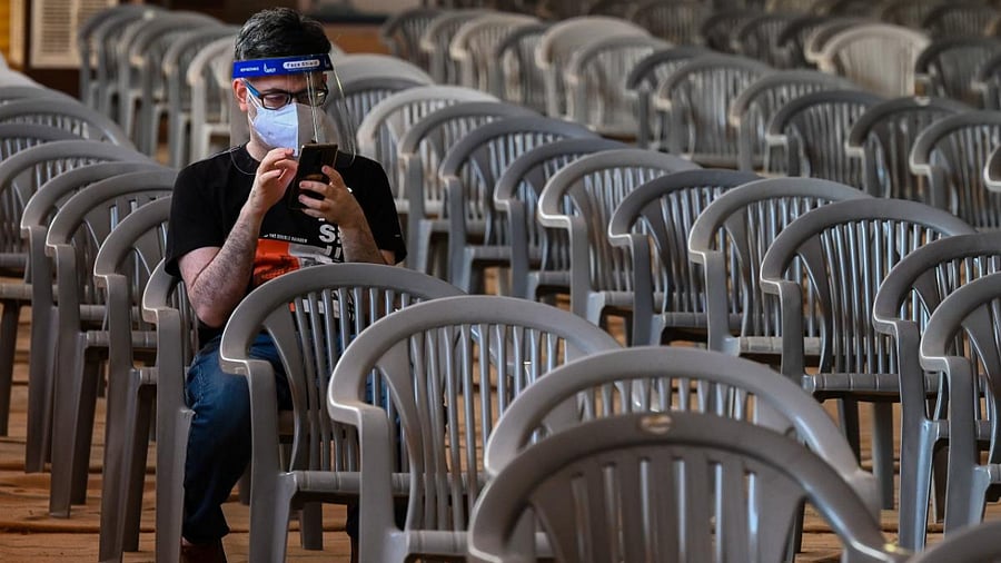 A man waits to get a dose of the coronavirus vaccine at a vaccination centre of the BLK-Max hospital in New Delhi. Credit: AFP Photo