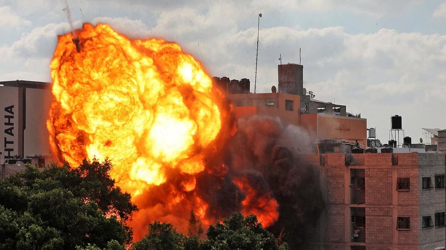 A ball of fire engulf the Al-Walid building which was destroyed in an Israeli airstrike on Gaza city. Credit: AFP Photo