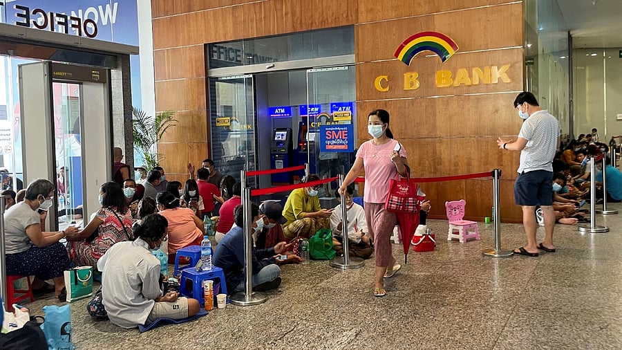 People have to queue for hours for the few functioning cash dispensing machines. Credit: Reuters Photo
