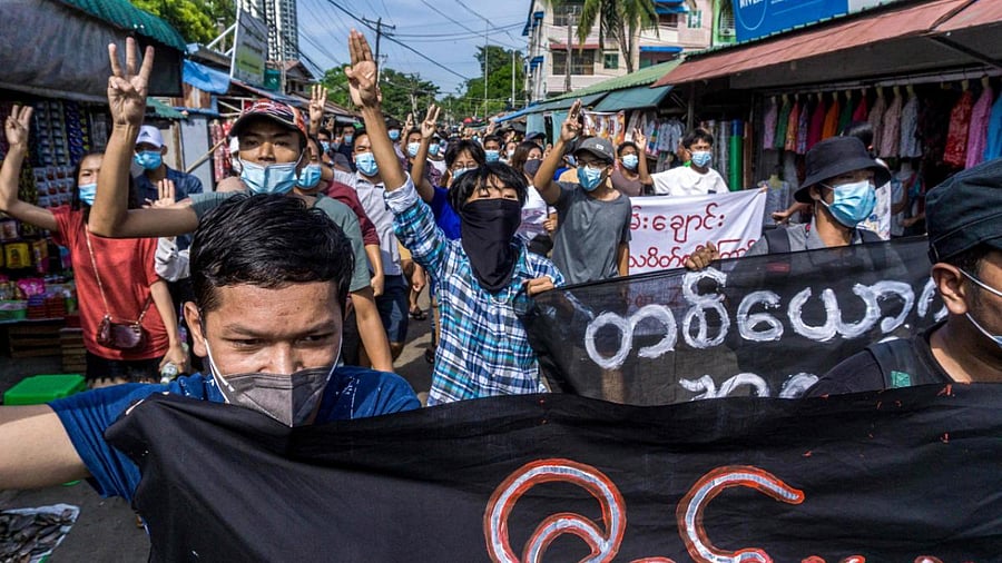 Protesters make the three-finger salute during a demonstration against the military coup in Yangon. Credit: AFP Photo