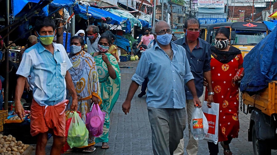 People shop at a vegetable and fruit market amid Covid-19 coronavirus pandemic in Kochi on May 7, 2021. Credit: AFP File Photo