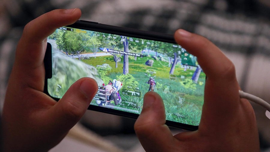 An Iraqi Kurdish youth plays the PUBG video game on his mobile phone in Arbil, the capital of the autonomous Kurdish region in northern Iraq. Credit: AFP Photo