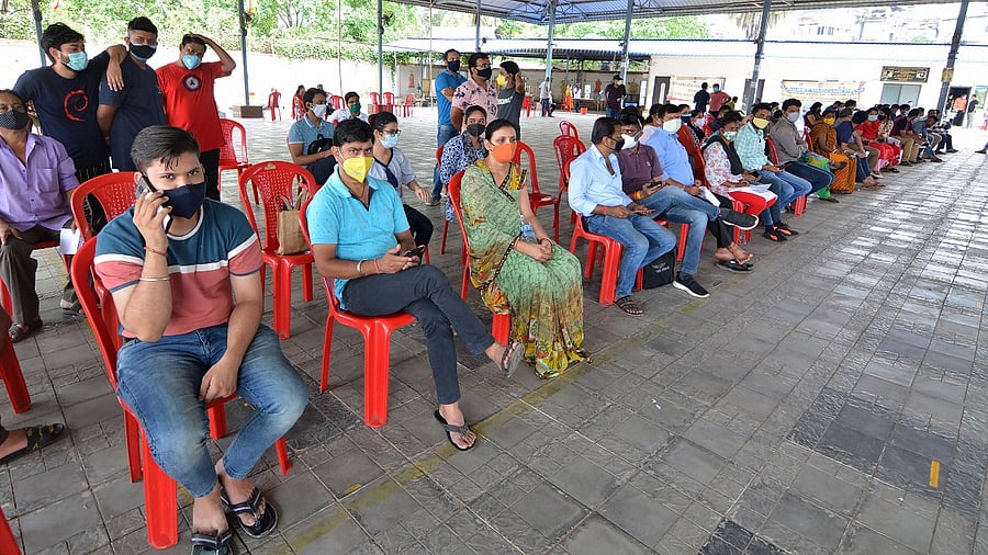 Young beneficiaries wait to receive Covid-19 vaccine dose, at a vacination centre in Guwahati. Credit: PTI Photo