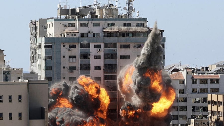 A ball of fire erupts from the Jala Tower as it is destroyed in an Israeli airstrike in Gaza city controlled by the Palestinian Hamas movement. Credit: AFP Photo
