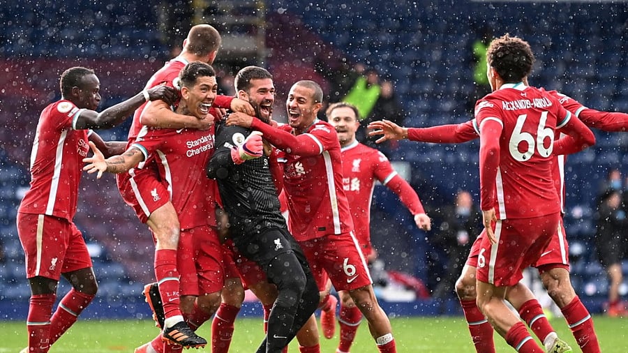 Liverpool's Alisson celebrates scoring their second goal with teammates. Credit: Reuters Photo