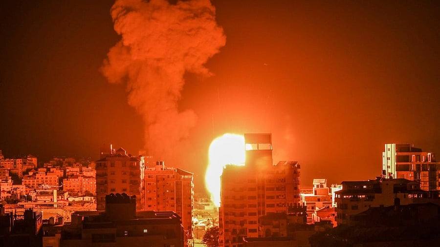 Fire and smoke rise above buildings in Gaza City as Israeli warplanes target the Palestinian enclave. Credit: AFP Photo