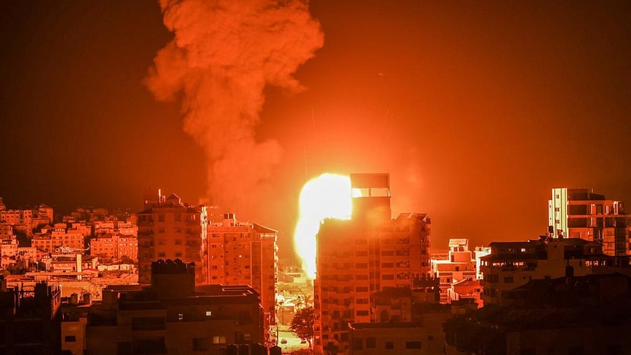 Fire and smoke rise above buildings in Gaza City as Israeli warplanes target the Palestinian enclave. Credit: AFP Photo