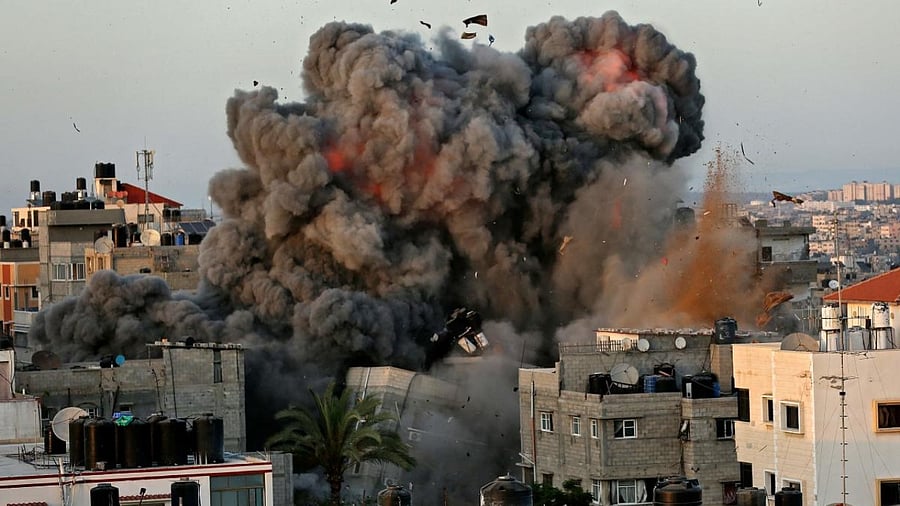 A ball of fire and thick smoke erupts from a building in Gaza City's Rimal residential district during massive Israeli bombardment on the Hamas-controlled enclave. Credit: AFP Photo