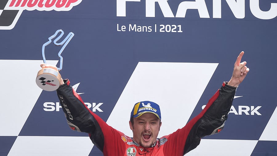 Australia's Ducati rider Jack Miller celebrates on the podium after winning the French MotoGP. Credit: AFP Photo