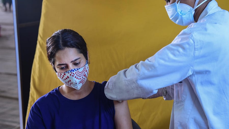 A young beneficiary receives her first dose of Covid-19 vaccine. Credit: PTI Photo