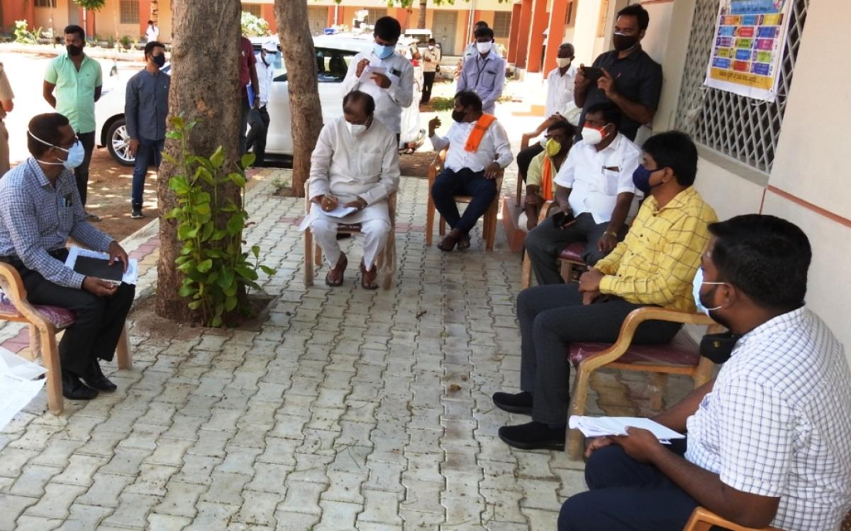 District In-charge Minister K C Narayana Gowda holds a meeting with the officials in Pandavapura, Mandya district, on Monday. DH Photo